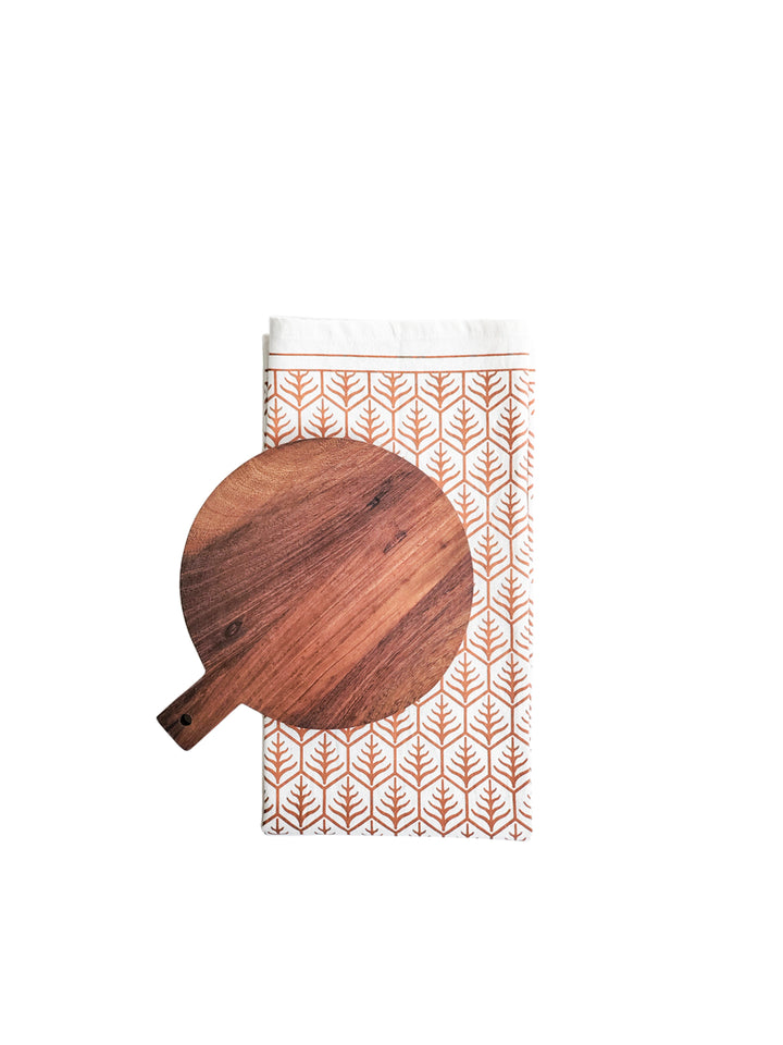 handcrafted wood serving board from sturdy Albizia hardwood and light brown hand screen-printed tea towel on natural cotton