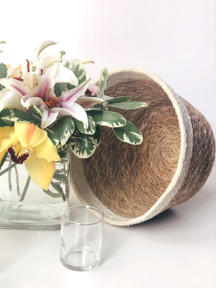 Savar Plant Bowl set is made of seagrass leaves with natural jute accent at top. This bowl can dress up your plain vase of flowers just right - Giving it a natural makeover.
