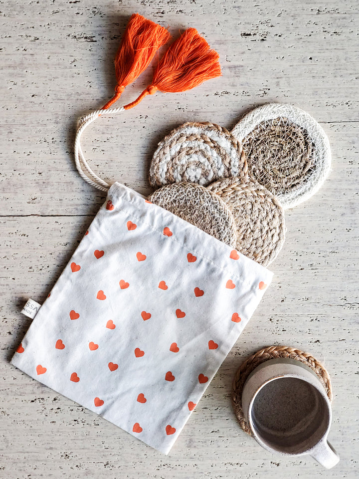 Mini coaster gift set (x 4) handmade with 100% Jute and seagrass and hand screen printed drawstring heart pouch handmade by Bangladesh Women Artisans.